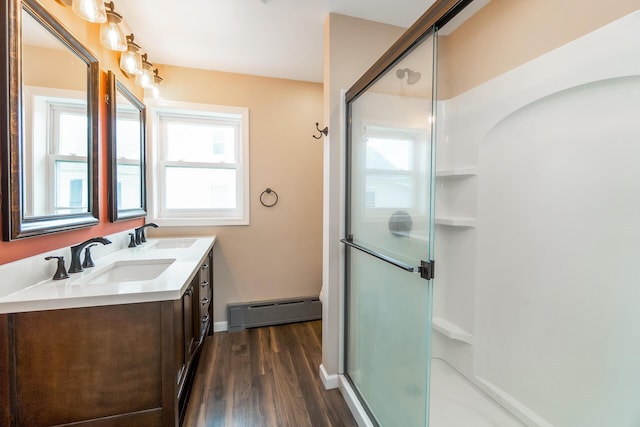 247 S 7th St, Lehighton, PA 18235 - full bath with baseboard heating, double vanity, wood finished floors, and a shower with shower door