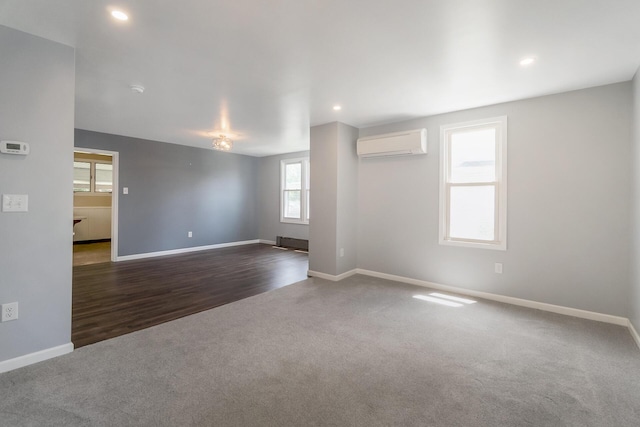 247 S 7th St, Lehighton, PA 18235 - carpeted empty room with a wall mounted AC, recessed lighting, and wood finished floors