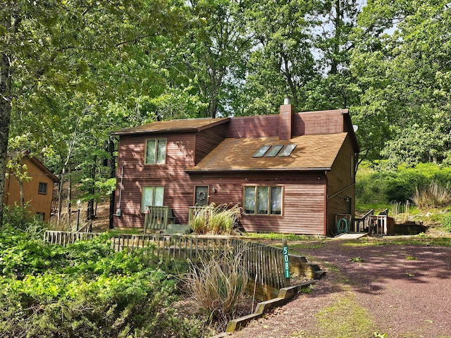5081 Woodbridge Dr E, Bushkill, PA 18324 - rustic home with a chimney and roof with shingles