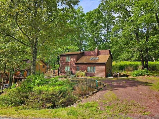 5081 Woodbridge Dr E, Bushkill, PA 18324 - view of front facade featuring driveway and a chimney
