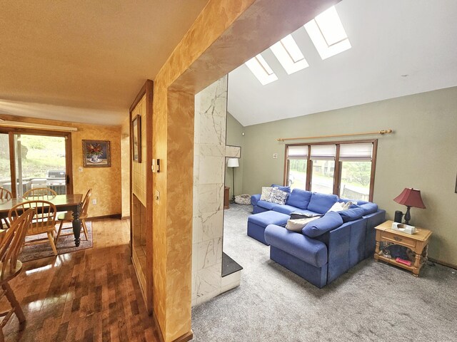 5081 Woodbridge Dr E, Bushkill, PA 18324 - living area with a skylight, vaulted ceiling, and wood finished floors