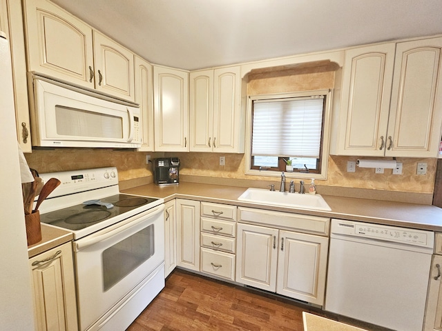 5081 Woodbridge Dr E, Bushkill, PA 18324 - kitchen with white appliances, cream cabinets, a sink, dark wood-type flooring, and light countertops