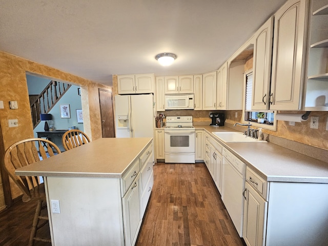 5081 Woodbridge Dr E, Bushkill, PA 18324 - kitchen featuring white appliances, a sink, open shelves, dark wood-style flooring, and a breakfast bar area