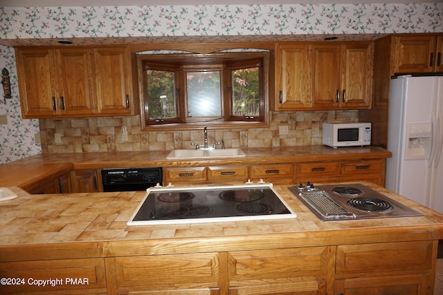 6760 Bear Creek Blvd, Bear Creek Township, PA 18702 - kitchen with wooden counters, a sink, wallpapered walls, black appliances, and tasteful backsplash