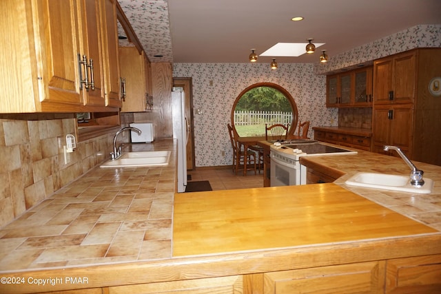 6760 Bear Creek Blvd, Bear Creek Township, PA 18702 - kitchen with wood counters, white appliances, wallpapered walls, and a sink