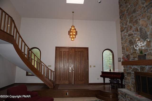 6760 Bear Creek Blvd, Bear Creek Township, PA 18702 - entryway featuring a fireplace, stairs, a high ceiling, and baseboards