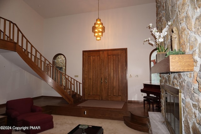 6760 Bear Creek Blvd, Bear Creek Township, PA 18702 - entrance foyer with a fireplace, stairs, baseboards, and a towering ceiling