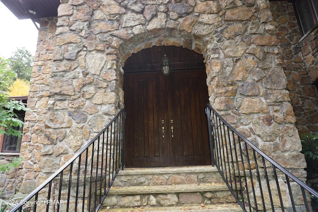 6760 Bear Creek Blvd, Bear Creek Township, PA 18702 - view of exterior entry with stone siding and a fireplace