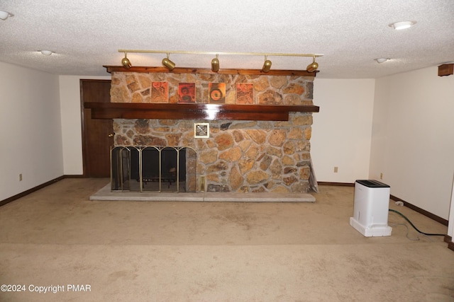 6760 Bear Creek Blvd, Bear Creek Township, PA 18702 - unfurnished living room with a textured ceiling, carpet flooring, baseboards, and a stone fireplace