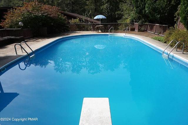 6760 Bear Creek Blvd, Bear Creek Township, PA 18702 - view of pool with a deck, a fenced in pool, a diving board, and fence