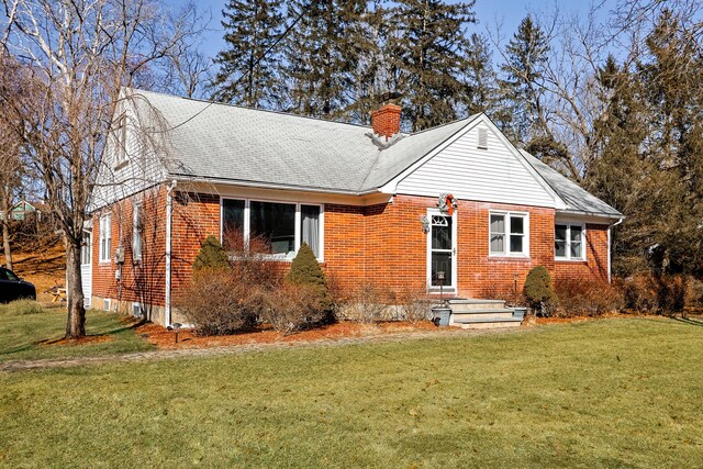 840 Columbus Ave, Stroudsburg, PA 18360 - view of front of house featuring brick siding, a chimney, a front yard, and a shingled roof