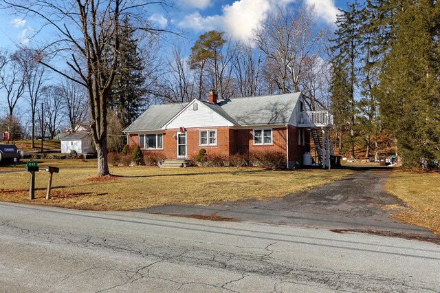 840 Columbus Ave, Stroudsburg, PA 18360 - view of front of property featuring asphalt driveway, a chimney, brick siding, and a front yard