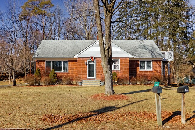 840 Columbus Ave, Stroudsburg, PA 18360 - view of front facade featuring brick siding, a front lawn, and a shingled roof