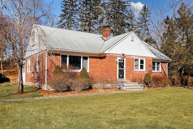 840 Columbus Ave, Stroudsburg, PA 18360 - view of front of property with brick siding, a chimney, a front yard, and roof with shingles