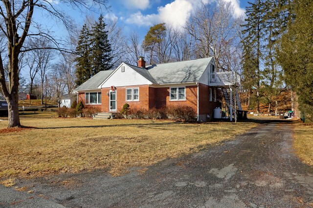 840 Columbus Ave, Stroudsburg, PA 18360 - view of front of property with a chimney, brick siding, a front lawn, and asphalt driveway