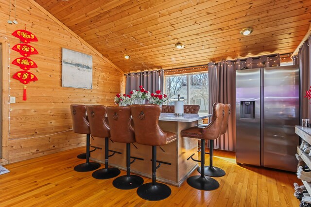 840 Columbus Ave, Stroudsburg, PA 18360 - dining area featuring wooden ceiling, vaulted ceiling, wooden walls, and light wood-type flooring