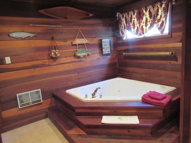 full bath with a tub with jets, visible vents, and wooden walls