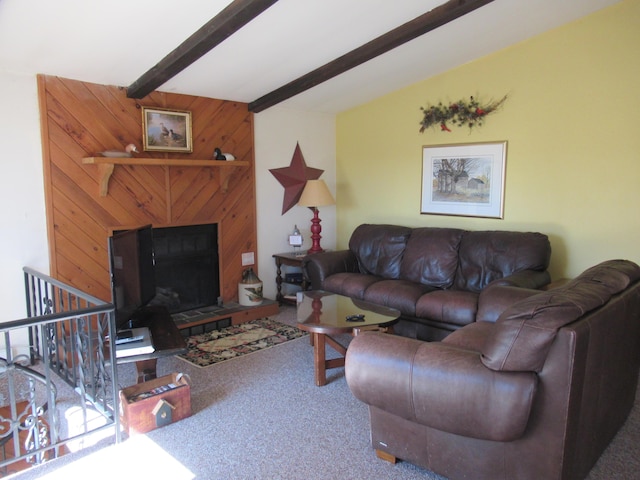 living area with beam ceiling and carpet flooring