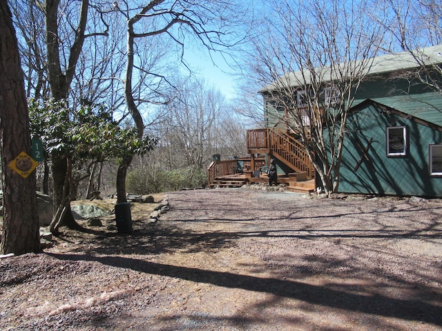 view of road featuring stairway and driveway