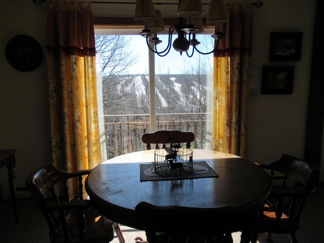 dining space featuring a notable chandelier and a healthy amount of sunlight