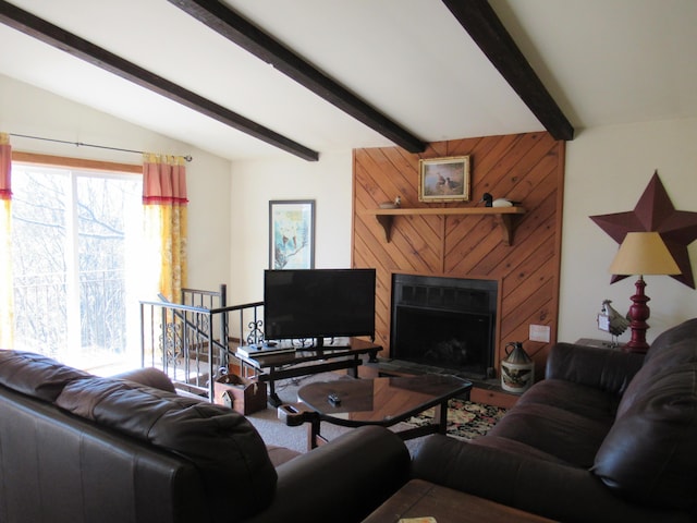 living room featuring vaulted ceiling with beams and a fireplace