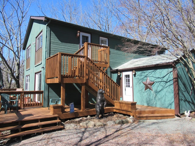 back of property with a wooden deck