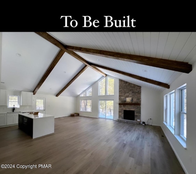 unfurnished living room featuring a fireplace, wood finished floors, a sink, and beamed ceiling