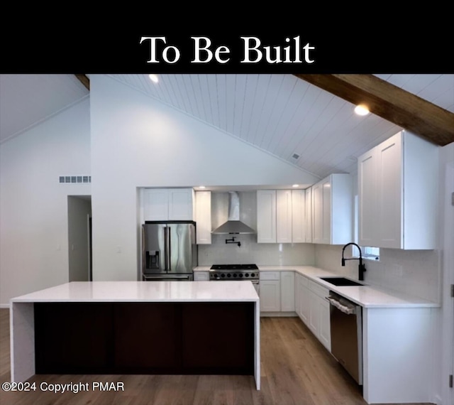 kitchen featuring visible vents, lofted ceiling with beams, wall chimney exhaust hood, appliances with stainless steel finishes, and a sink