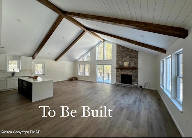 unfurnished living room featuring a sink, a fireplace, dark wood finished floors, and beam ceiling