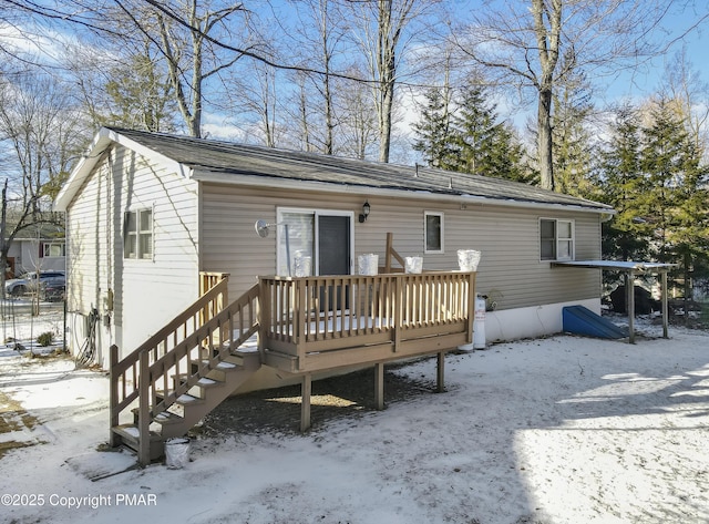 snow covered property featuring a deck