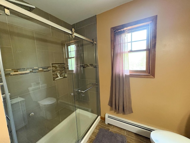 439 Cedar Dr, Long Pond, PA 18334 - full bathroom featuring toilet, a tile shower, baseboard heating, and tile patterned flooring