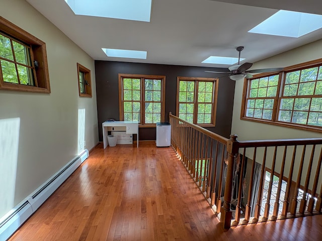 439 Cedar Dr, Long Pond, PA 18334 - hallway with a skylight, a baseboard radiator, hardwood / wood-style flooring, and healthy amount of natural light