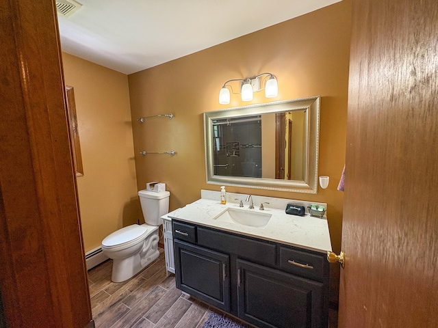 439 Cedar Dr, Long Pond, PA 18334 - bathroom with a baseboard radiator, vanity, wood finished floors, and toilet