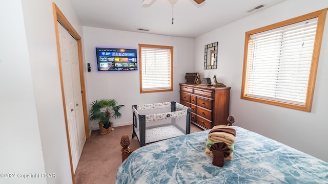 bedroom featuring ceiling fan, carpet floors, a closet, and visible vents