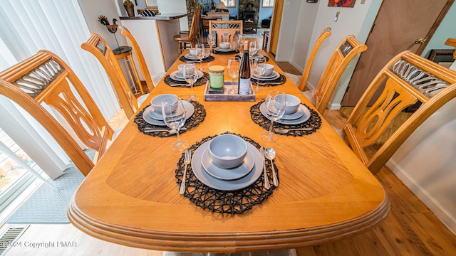 dining space featuring wood-type flooring