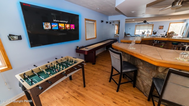 game room with ceiling fan and light hardwood / wood-style floors