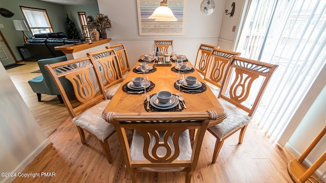 dining area with wood finished floors and baseboards