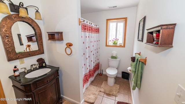 full bathroom featuring baseboards, visible vents, toilet, tile patterned floors, and vanity