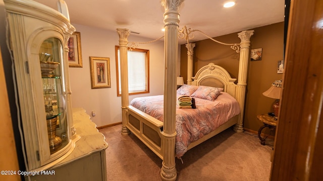 bedroom featuring ornate columns, carpet, and baseboards