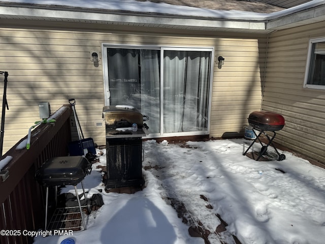 snow covered patio featuring grilling area