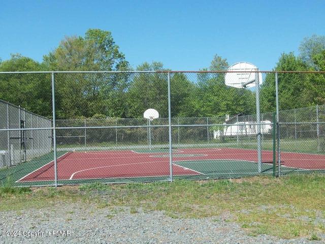 view of basketball court with community basketball court and fence