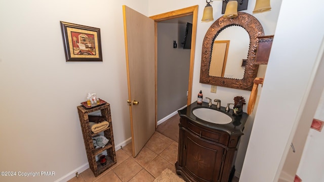 bathroom featuring tile patterned flooring, vanity, and baseboards