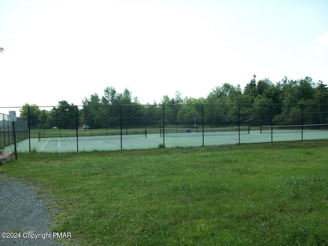 view of tennis court featuring fence