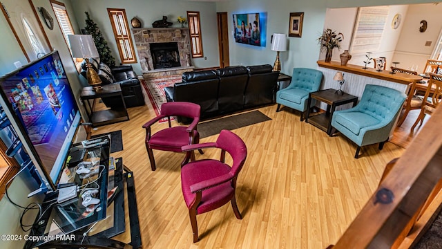 living room with wood-type flooring and a fireplace