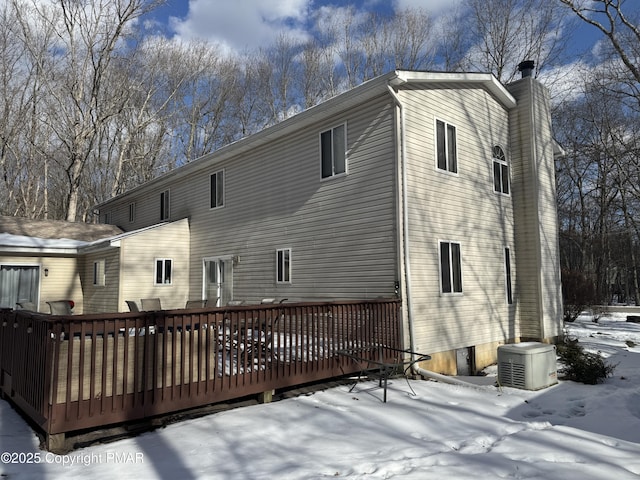 snow covered property featuring a wooden deck