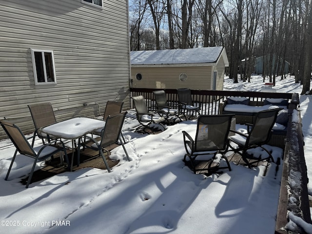 snow covered patio featuring outdoor dining space