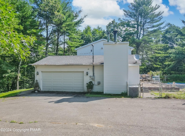 garage with aphalt driveway