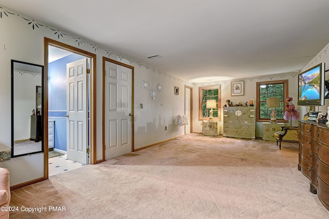 unfurnished living room featuring carpet flooring and visible vents