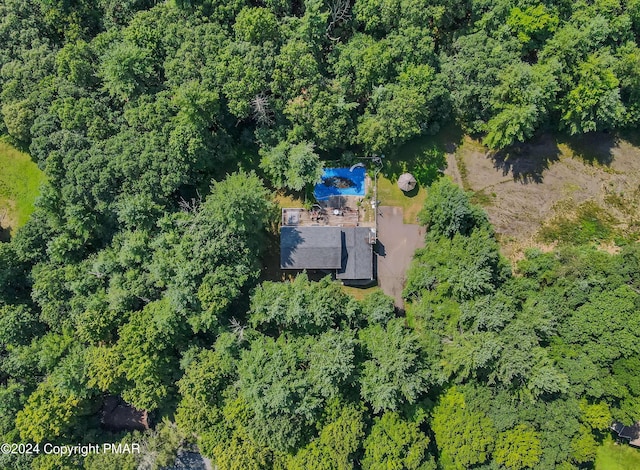 drone / aerial view with a wooded view