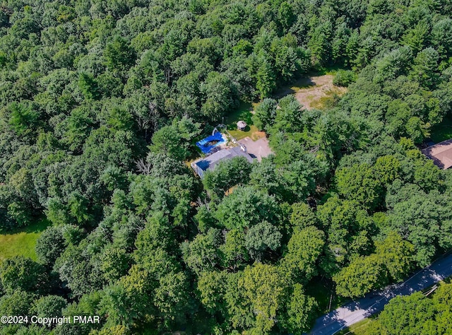 aerial view featuring a wooded view